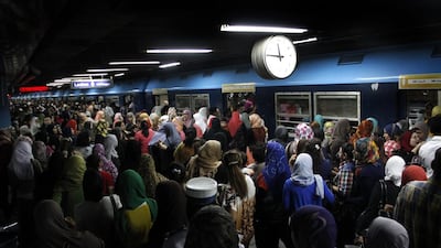 Egyptian women board a train at Al Shohadaa, (Martyrs) metro station.