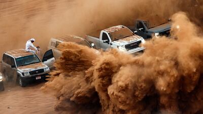 Enthusiasts gather to watch drivers drifting in the desert of Umm Al Quwain. AFP