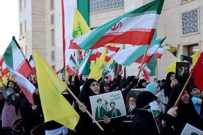 People carry Hezbollah, Iranian and Lebanese flags during a memorial ceremony for supreme leader Ayatollah Ali Khamenei at the Iranian Embassy in Beirut. AFP