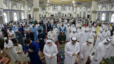 People during the morning Eid al-Fitr prayers at the Al Farooq Omar Bin Al Khattab Mosque in Dubai. Pawan Singh / The National