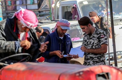 Lebanese security general officer inspects the paper of a Syrian refugee as he leaves a refugee camp in the village of Arsal to return home to his village in Al-Qalamoun area in the western Damascus countryside. EPA