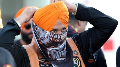 A member of Singhs Motorcycle Club UAE gets ready for the morning bike ride from Enoc gas station on Hatta – Oman road in Dubai. Pawan Singh / The National