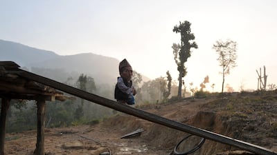 Chandra Bahadur Dangi, a 72-year-old Nepali who claims to be the world's shortest man at 56 centimetres (22 inches) in height, stands near his home in Reemkholi village, Dang district, some 540 kilometres southwest of Kathamandu. AFP PHOTO/Prakash MATHE???