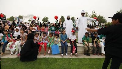 Volunteers with children before a show as part of the third Arab Orphan Day Ceremony held by Dar Al Ber Society in Dubai in April. Sarah Dea / The National