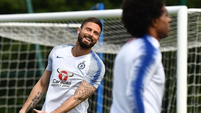 Chelsea's French striker Olivier Giroud shares a joke during training. AFP