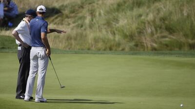 Dustin Johnson, right, talks to a rules official on the fifth green during the final round of the US Open at Oakmont Country Club on Sunday. John Minchillo / AP Photo
