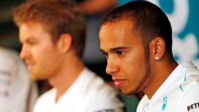 Mercedes driver Lewis Hamilton of Britain, right, and his teammate Nico Rosberg of Germany listen to a reporter's question during a press conference. Both will square off in the Chinese Grand Prix this weekend. Vincent Thian / AP Photo
