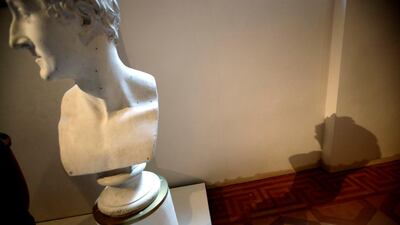 The 'Bust of Leopoldo Cicognara' by Antonio Canova casts its shadow against a wall showing a dark stain indicating the level the water reached during the latest high tide flooding, at the Accademia Gallery, in Venice. Luca Bruno / AP Photo