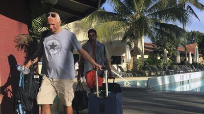 Tourists check out of their hotel before being taken to Banjul airport in Gambia on January 18, 2017 as special flights were being organised to evacuate British, Dutch and Belgian visitors left in droves as the threat of a regional military intervention loomed with president Yahya Jammeh clinging on to power even as his mandate expires on Thursday. AP Photo