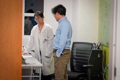 Yangjiao Chen and Yongyang Liu load a driving simulator programme at Georgia Tech's Autonomous and Connected Transportation Laboratory. Joshua Longmore / The National