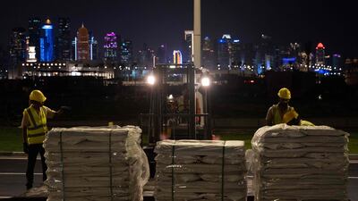 Labourers work to build a structure along a street in Doha ahead of the Qatar 2022 FIFA World Cup football tournament. AFP