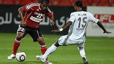 Al Ahli’s Pinga, left, controls the ball as Baniyas’s Saqer Hammadi challenges him.