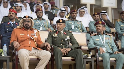Major General Abdullah Muhair Al Ketbi, left, and Major General Pilot Sheikh Ahmed bin Tahnoon bin Mohamed Al Nahyan, Chairman of the UAE National and Reserve Service Authority, centre, attend the 2017 International Defence Exhibition and Conference opening ceremony. Hamad Al Kaabi / Crown Prince Court - Abu Dhabi