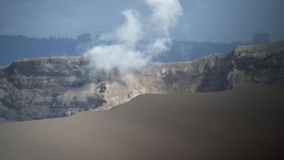 White steam emits from Taal volcano crater as seen from a Philippine airforce helicopter during an aerial survey. Ted Aljibe / AFP
