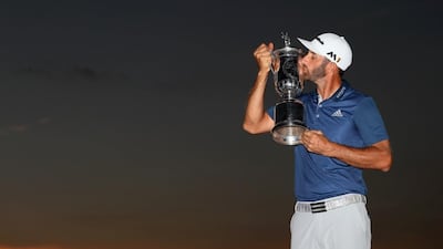 Dustin Johnson kisses the winner's trophy after his victory at the US Open at Oakmont Country Club, Pennsylvania. Andrew Redington / Getty Images / AFP