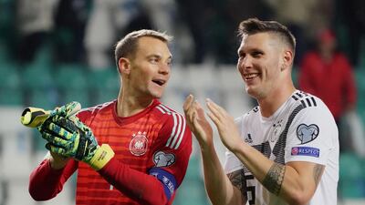 Germany's goalkeeper Manuel Neuer and defender Niklas Suele celebrate their victory over Estonia in Tallinn. AFP