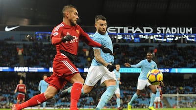 Manchester City's Nicolas Otamendi, centre, vies for the ball with Watford's Roberto Pereyra. Rui Vieira / AP Photo