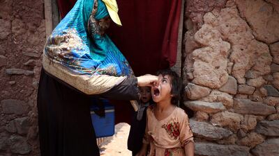 A health worker gives polio vaccine drops to a child during a three-day vaccination drive in Islamabad, Pakistan. EPA