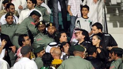 Diego Maradona is restrained by police after confronting Al Shabab fans.