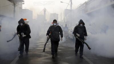 Firefighters disinfect streets in an effort to stop the spread of coronavirus in Tehran, March 13. EPA