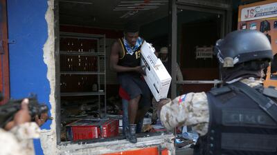 Police officers stop a looter. Reuters
