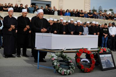 Israeli Druze Sheikhs recite prayers in front of the coffin of 17-year-old Tiran Fero, on November 24, 2022, during his funeral ceremony in Daliyat al Karmel, around 20 kms southeast of Haifa. - The body of Tiran Fero, who was critically wounded in a car accident on November 22, was snatched by Palestinian militants in the occupied West Bank and returned to his relatives, following intense talks to avoid an escalation of violence. Israeli Prime Minister Yair Lapid had threatened tough reprisals against those who had taken the body of the Israeli teenager. (Photo by JALAA MAREY / AFP)