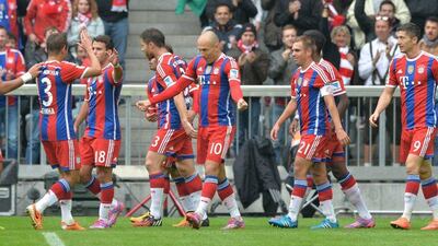 Bayern Munich's Arjen Robben, centre, celebrates scoring his side's second goal in a 4-0 win over Hannover on Saturday in the Bundesliga. Peter Kneffel / EPA / October 4, 2014