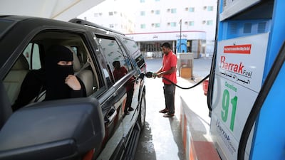 A Saudi woman, Amira, who works in Aramco, refuels her car as she makes her way to her office in Dammam, Saudi Arabia. Hamad I Mohammed / Reuters