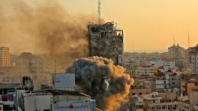 Heavy smoke and fire rise from Al-Sharouk tower as it collapses after being hit by an Israeli air strike, in Gaza City on May 12, 2021. An Israeli air strike destroyed a multi-storey building in Gaza City today, AFP reporters said, as the Jewish state continued its heavy bombardment of the Palestinian enclave. AFP