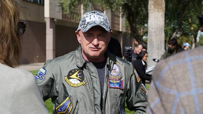 Senator Mark Kelly speaks with supporters ahead of a campaign event in Phoenix. Willy Lowry / The National
