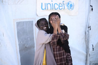 Displaced Sudanese girls play outside a Unicef tent in Port Sudan. Reuters