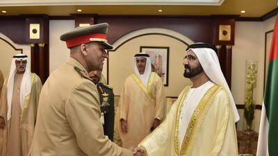Sheikh Mohammed bin Rashid shakes the hand of an officer at the graduation ceremony.