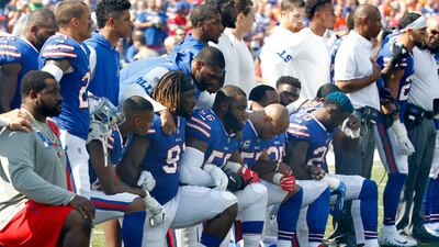 Buffalo Bills players 'take a knee' during the playing of the national anthem prior to an NFL football game against the Denver Broncos. AP Photo/Jeffrey T. Barnes