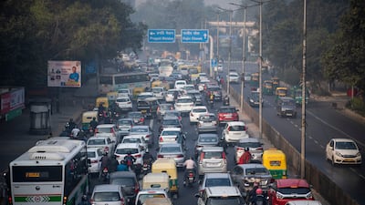 In this picture taken on November 25, 2021, people commute along a street amid smoggy conditions in New Delhi. AFP