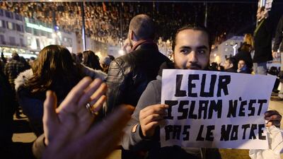 A man holds up a sign that read in French, “Their Islam is not ours” as they rally to pay tribute in Marseille, on January 7, 2015, following an attack by unknown gunmen on the offices of the satirical weekly, Charlie Hebdo in Paris earlier in the day. France’s Muslim leadership sharply condemned the shooting at the Paris satirical weekly that left at least 12 people dead as a “barbaric” attack and an assault on press freedom and democracy. BORIS HORVAT Boris Horvat / AFP photo