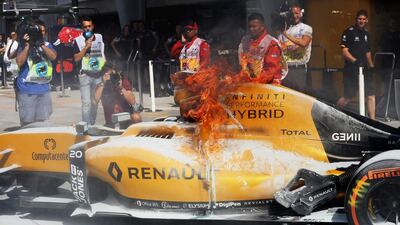 The car of Denmark’s Kevin Magnussen, who drives for Renault Sport F1, burns in the pit during a practice for the Malaysia Formula One Grand Prix at Sepang Circuit on September 30, 2016, in Kuala Lumpur, Malaysia. Mark Thompson / Getty Images