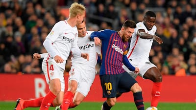 Barcelona's Lionel Messi dribbles past Sevilla's Simon Kjaer and Quincy Promes. AFP