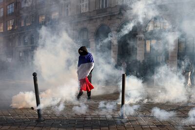 A protester wrapped in the French flag on Place de l'Opera in Lille. AFP
