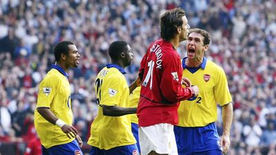 Ruud van Nistelrooy of Manchester United is mobbed by Arsenal players after missing a penalty in 2003. The Arsenal players had accused van Nistelrooy of diving. Getty Images