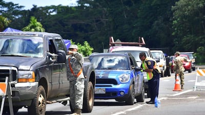 Authorities, including police and the National Guard, check the identification of returning evacuees to their homes at Leilani Estates near the town of Pahoa on May 6, 2018. Frederic Brown / AFP