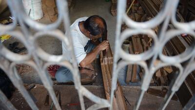 Nepalese woodcarver Hari Bahadur Shilpakar works in a workshop in Bhaktapur on the outskirts of Kathmandu. Prakash Mathema / AFP
