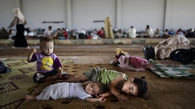 Syrian children take refuge at the Bab Al-Salameh border crossing. Muhammed Muheisen / AP