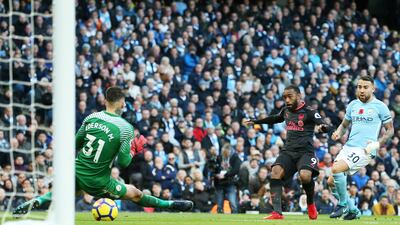 Alexandre Lacazette, centre, scores against Manchester City six minutes after coming on as a substitute. Nigel Roddis / EPA