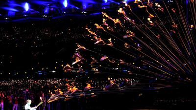 Former Paralympic archer, Margaret Maughan, lights the cauldron. Toby Melville/Reuters