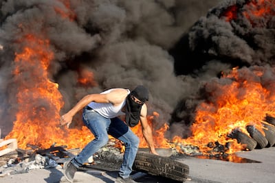 Palestinian demonstrators clash with Israeli soldiers as they demand that the army hands over the body of man who was shot dead by Israeli forces the previous night