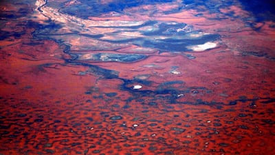 A small lake can be seen among sand dunes.