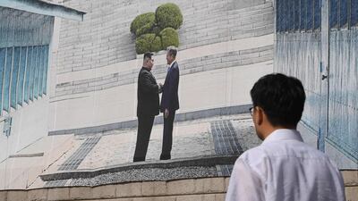 A banner in Seoul shows South Korean President Moon Jae-in meeting North Korean leader Kim Jong-un. AFP