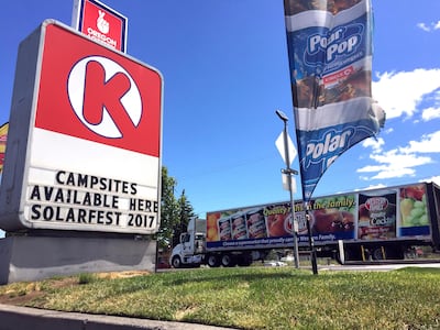 An advertisement for camping spaces for the August 21 total solar eclipse alongside a busy road in Madras, Oregon. Gillian Flaccus / AP Photo