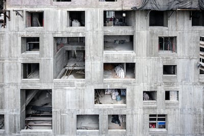 One of the images of a building under construction captures a man asleep on a makeshift bed. Ieva Saudargaite Douaihi