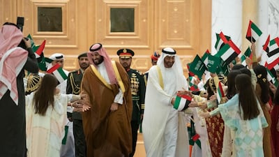 Sheikh Mohamed bin Zayed and Prince Mohamed bin Salman greet school children during a state visit at Qasr Al Watan.